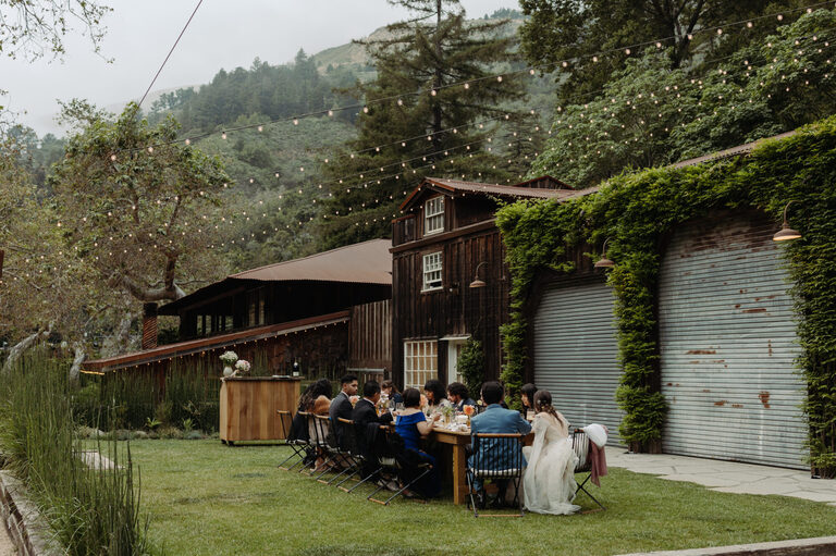 two families eat dinner at an intimate wedding reception at The Village Big Sur
