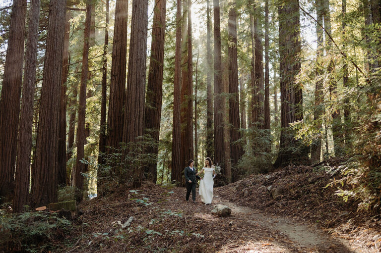 newlywed couple hikes through glen oaks Big Sur after getting married in the redwoods