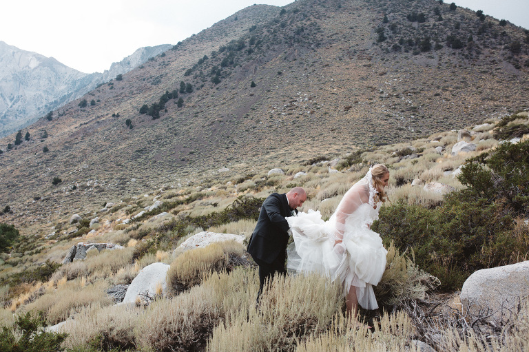 bride and groom hiking mountains for wedding portraits 
