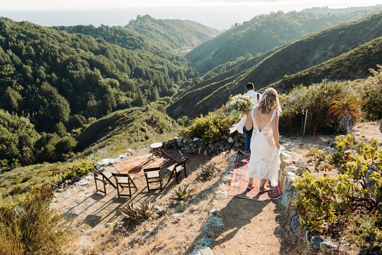bride and groom walking to their private elopement location in big sur