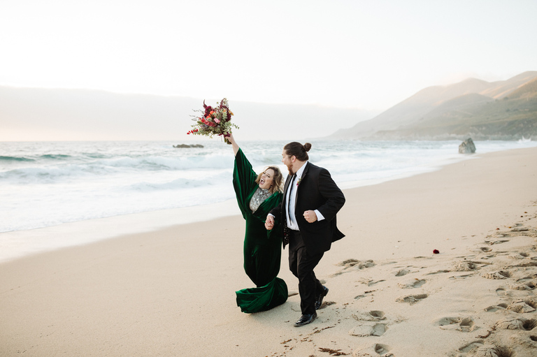 a couple runs on the beach after eloping in the redwoods of big sur